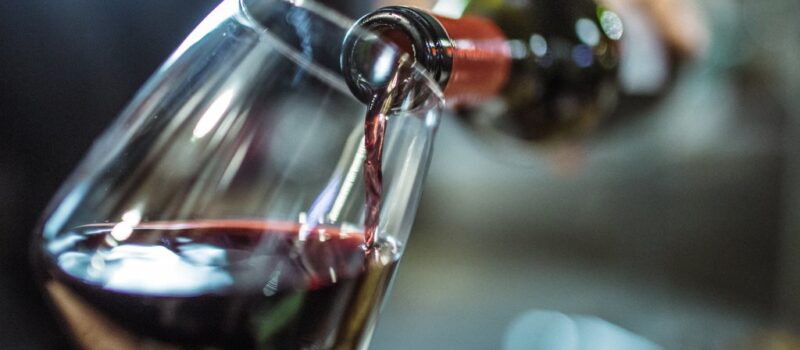 Close up of red wine being poured into a wine glass