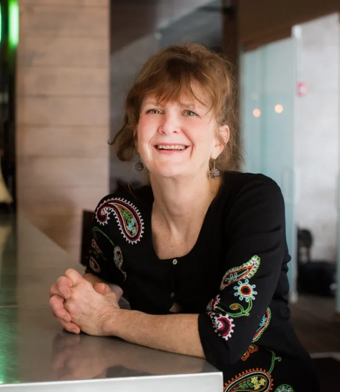 Image of Chef Deb Paquette sitting at a bar